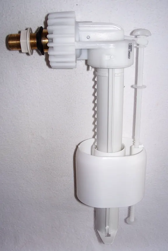 Plastic toilet fill valve with its float and threaded brass water inlet, removed from the tank