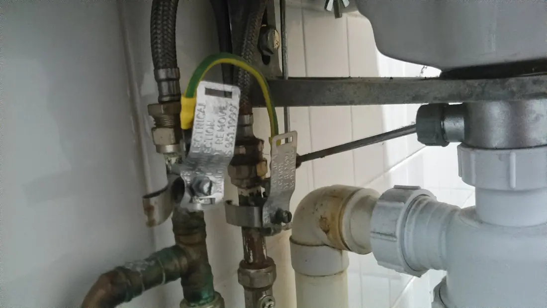 Drain and supply connections behind a sink